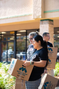 Berkshire Hathaway HomeServices Florida Properties Group employees volunteering in the 2021 Cabernet Sleigh food & toy drive