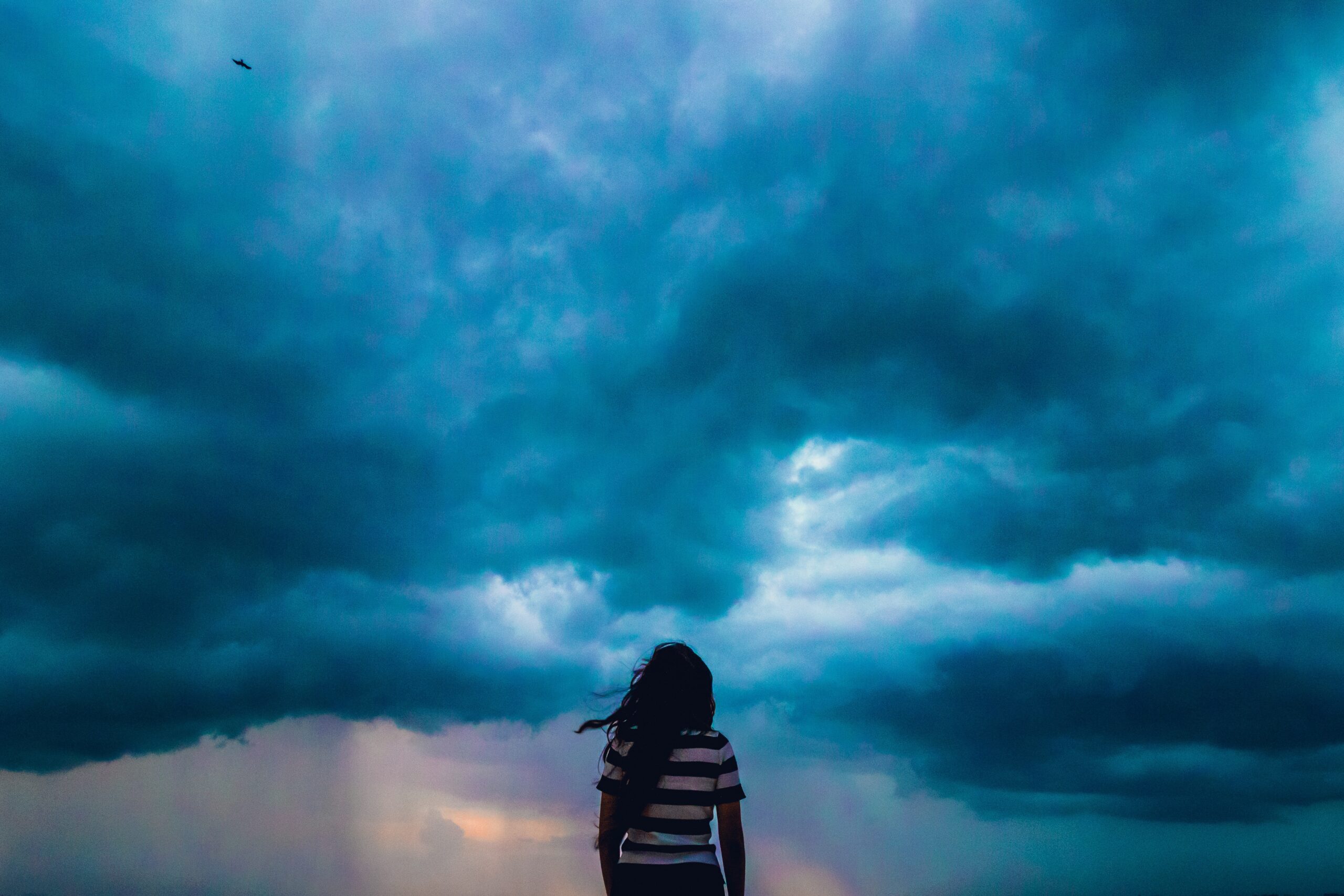 woman standing outside during a severe storm